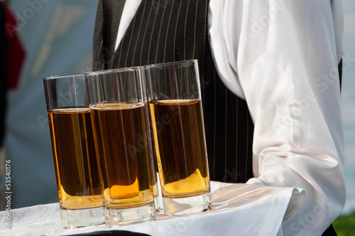 Waiter with dish of wine glasses