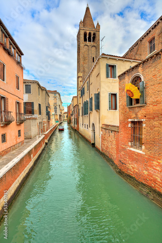 Small canal and typical buildings in Venice, Italy.