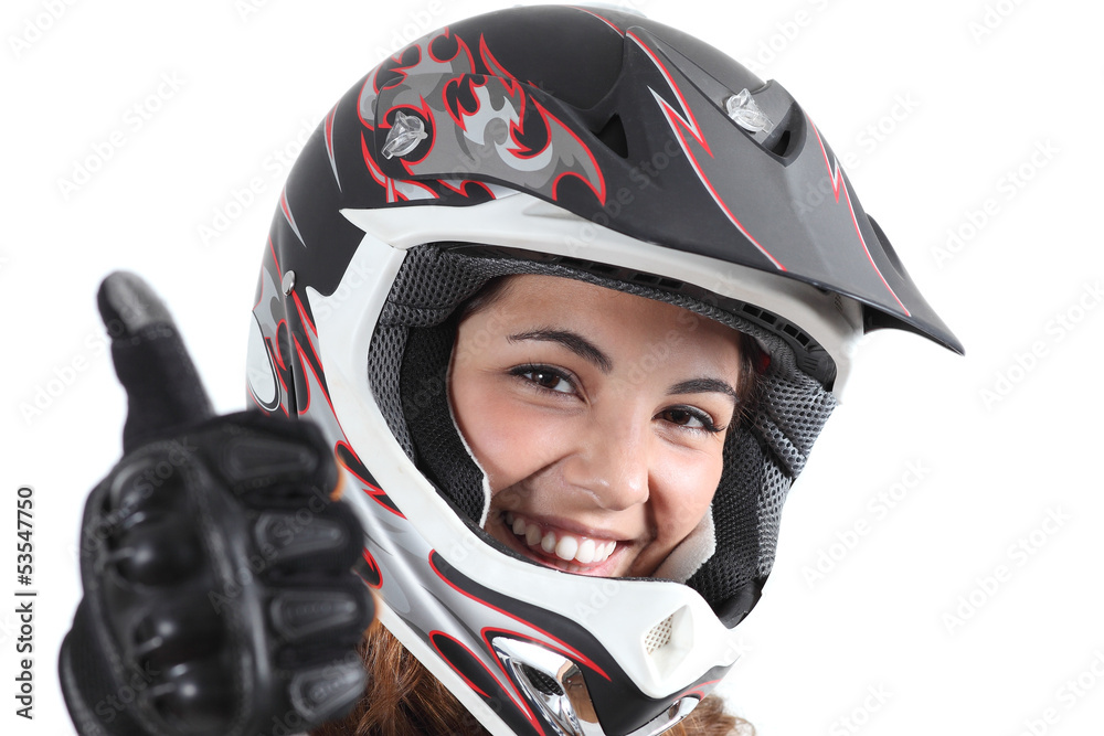 Happy biker woman with a motocross helmet and thumb up Happy biker woman with a motocross helmet and thumb up