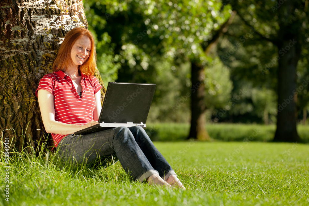 Woman with a notebook in a park Woman with a notebook in a park
