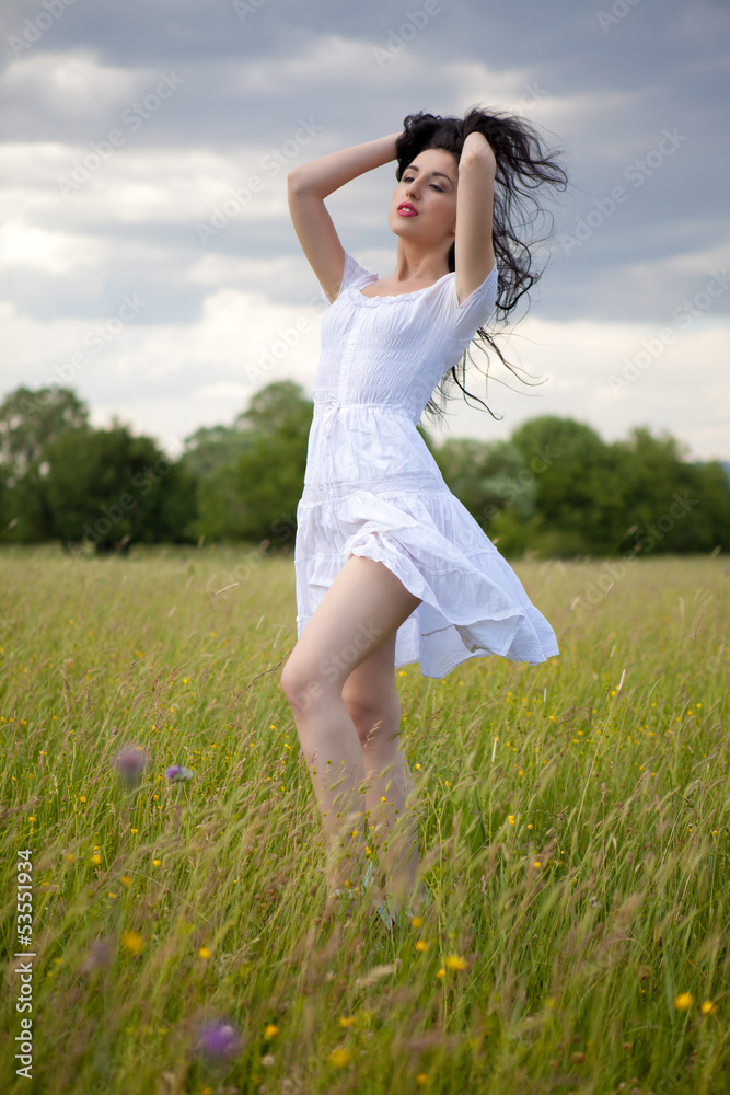 Pretty woman sitting on grass