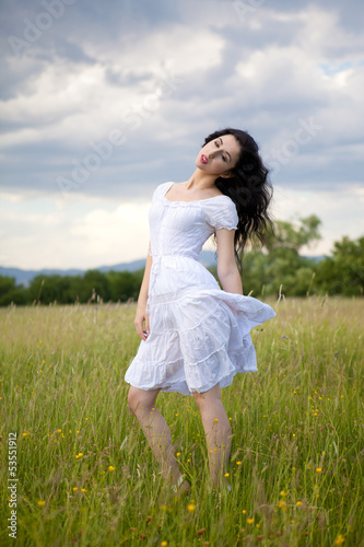 Sexy young woman on grass field