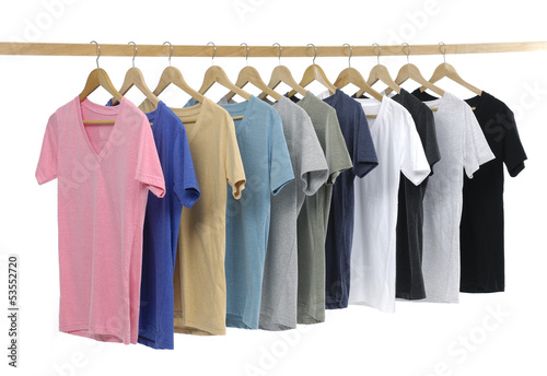 man clothes of different colors t-shirt on wooden hangers