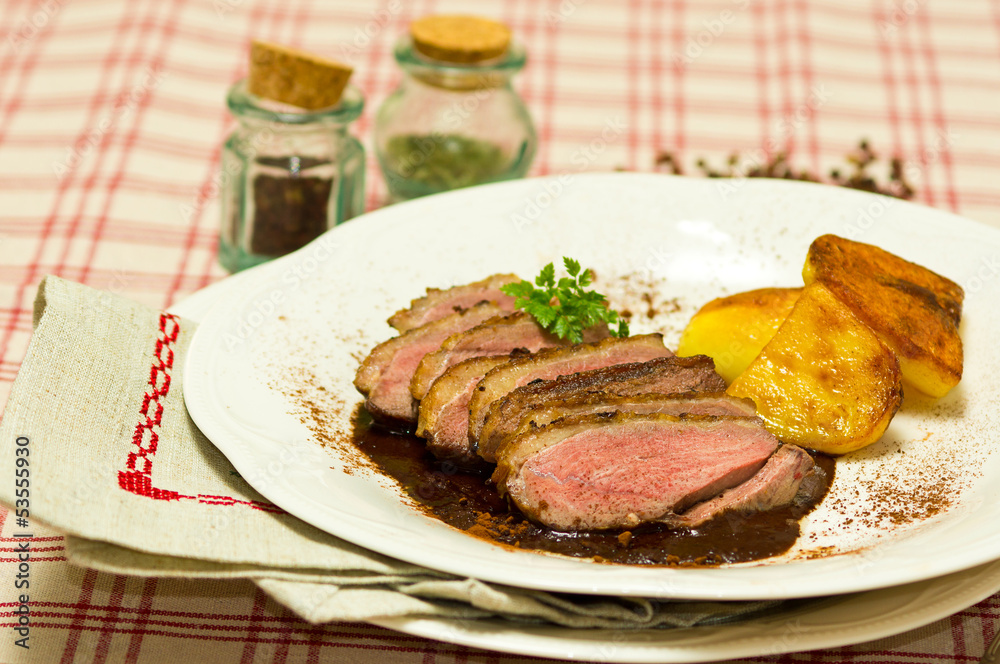 Breast of Duck (Magret de Canard) with cacao sauce and backed po
