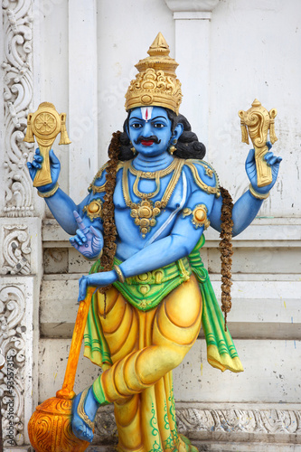 Colorful hindu god lord Vishnu statue on temple