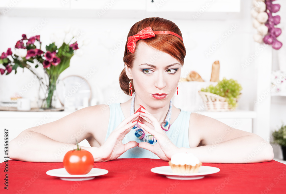 Woman choosing between healthy food and cake Woman choosing between healthy food and cake