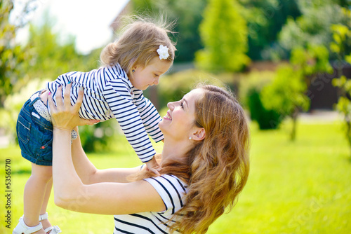 Young mother and cute daughter playing