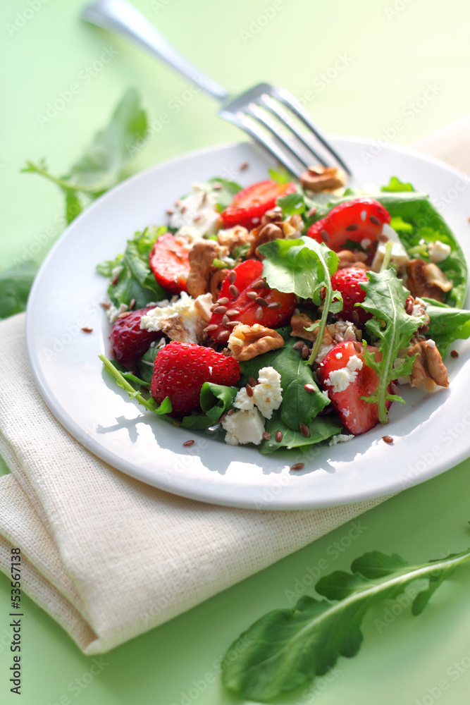 Salad with arugula, strawberries, goat cheese and walnuts Salad with arugula, strawberries, goat cheese and walnuts