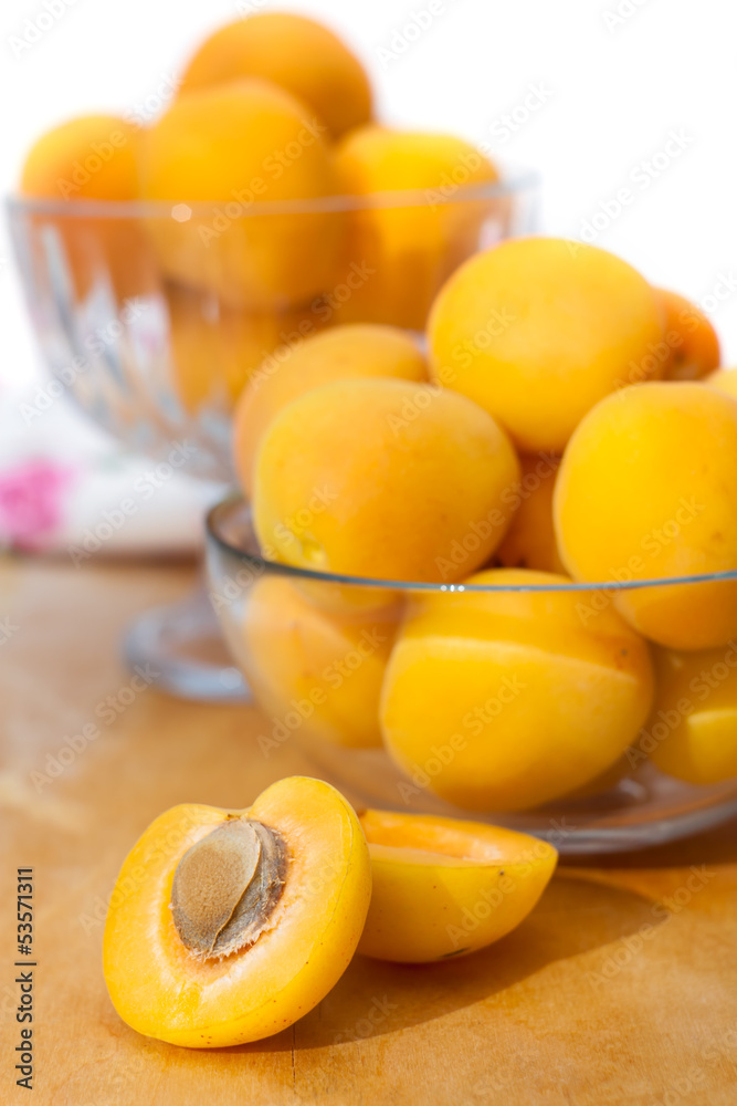 Ripe apricots in two glass bowls, selective focus