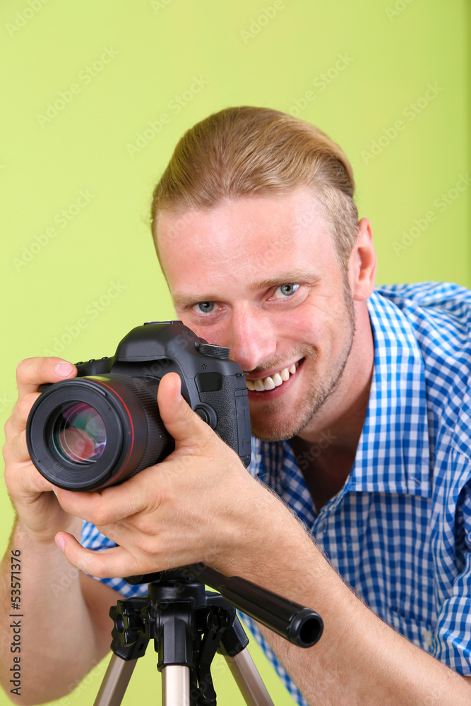 Handsome photographer with camera and tripod, Handsome photographer with camera and tripod,