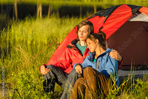 Camping couple enjoying sunset