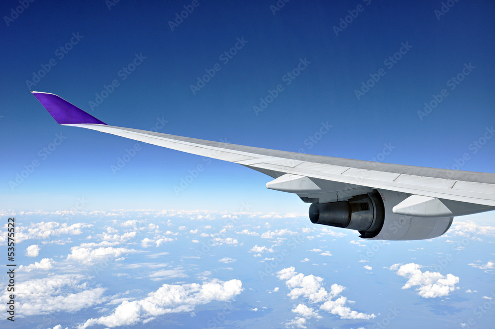 Fototapeta premium Blue sky with airplane wing - traveling concept