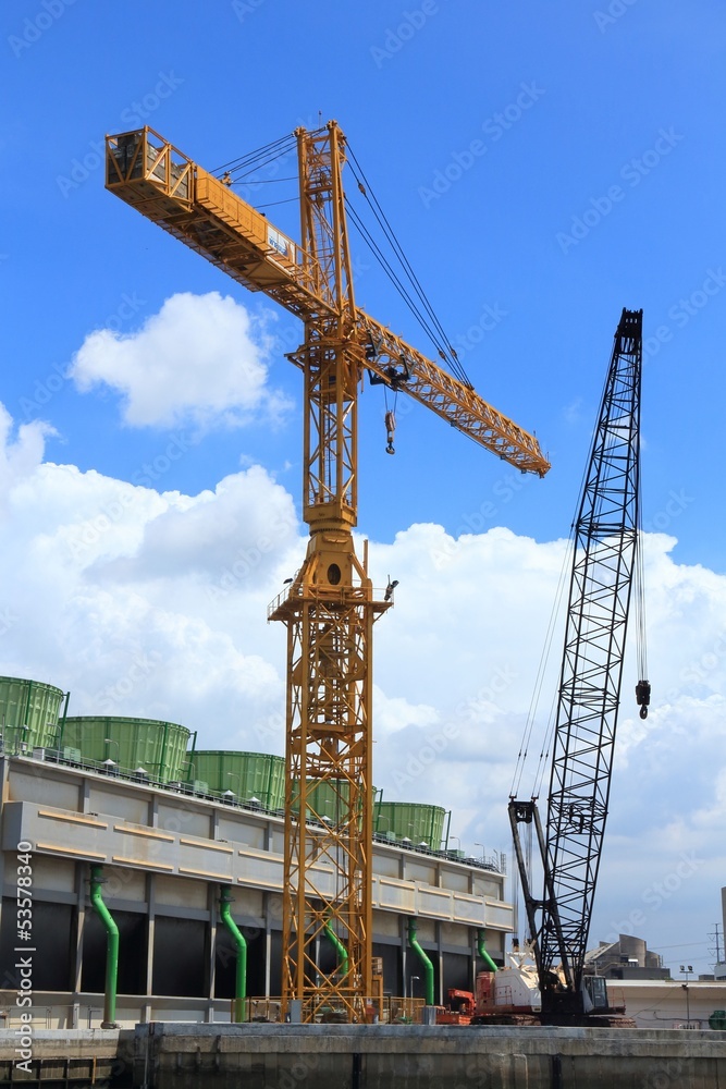 Buildings under Construction and Cranes under a Blue Sky.