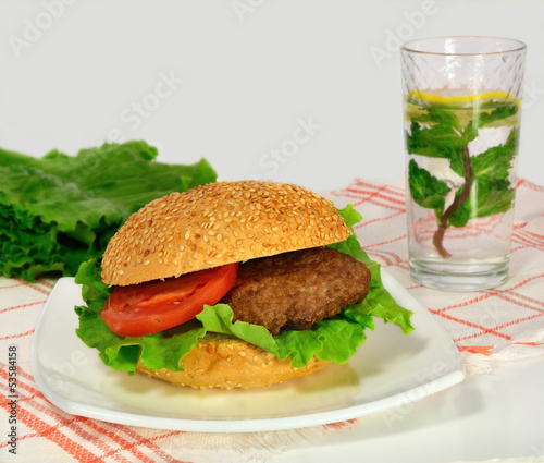 hamburger with vegetables and lemonade with mint