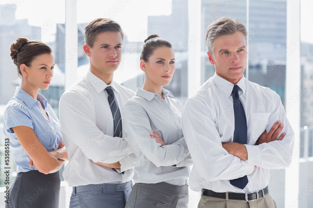 Serious business people standing together in line Serious business people standing together in line