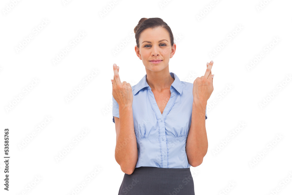 Smiling businesswoman with fingers crossed Smiling businesswoman with fingers crossed
