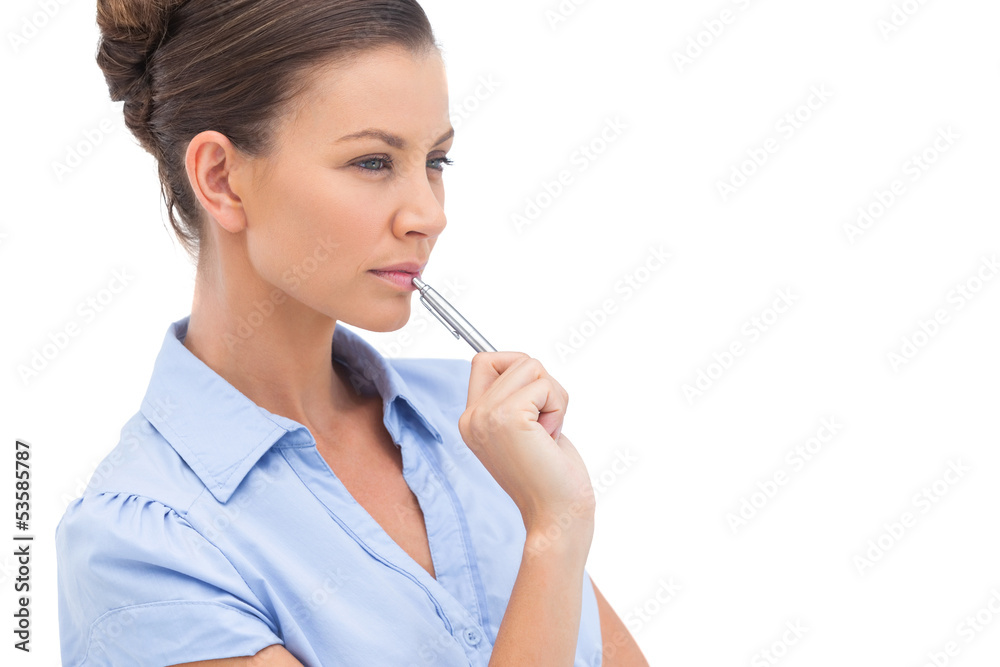 Concentrating businesswoman with pen Concentrating businesswoman with pen