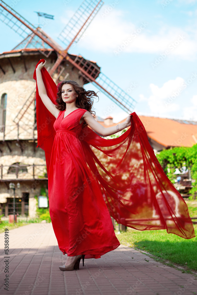 Naklejka premium Beautiful woman in a bright red dress