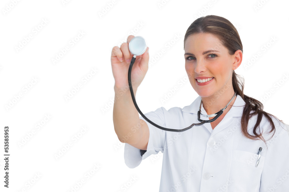 Happy nurse holding up stethoscope Happy nurse holding up stethoscope