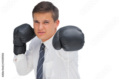 Businessman hitting with black boxing gloves © WavebreakmediaMicro