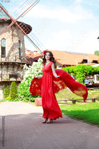 Beautiful woman in a bright red dress © Miramiska