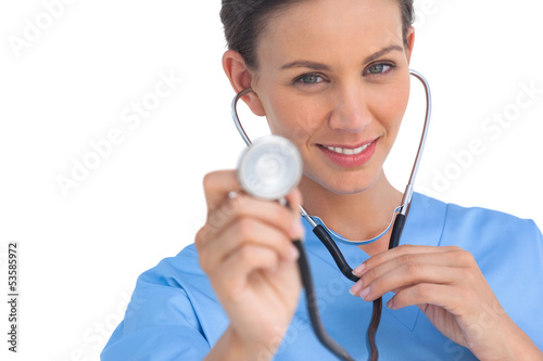Happy surgeon holding up stethoscope