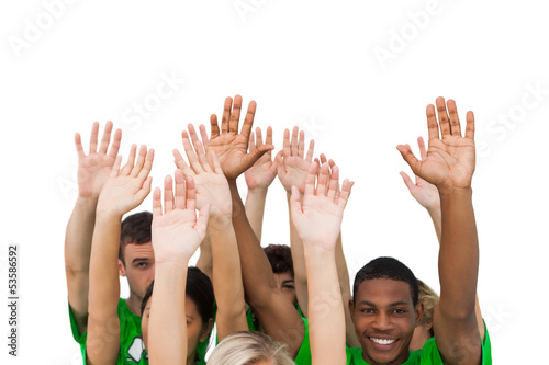 Smiling group of people raising arms