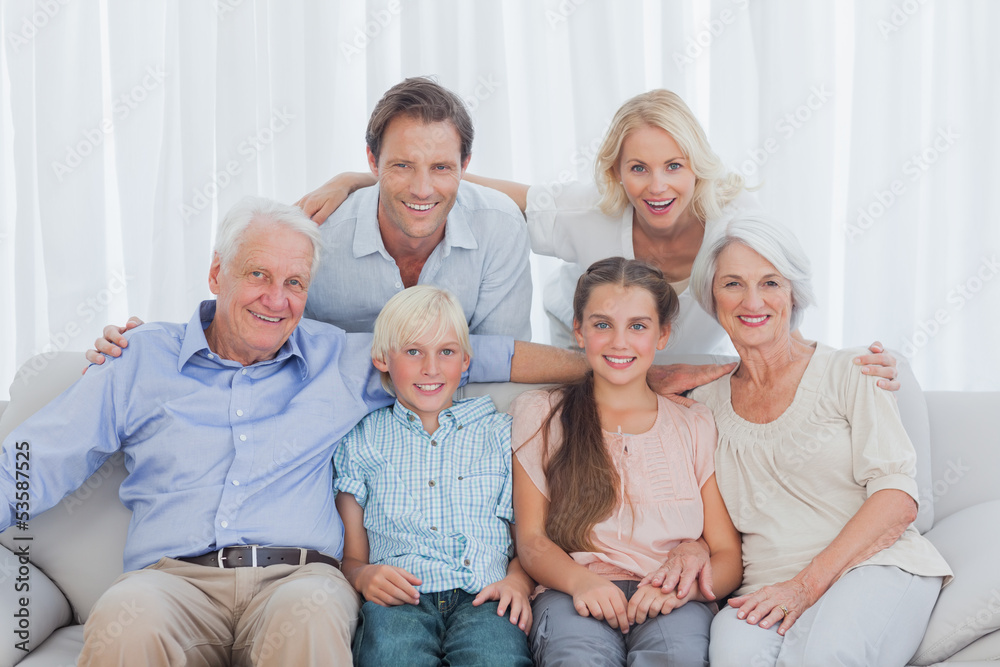 Extended family sitting together on couch Extended family sitting together on couch
