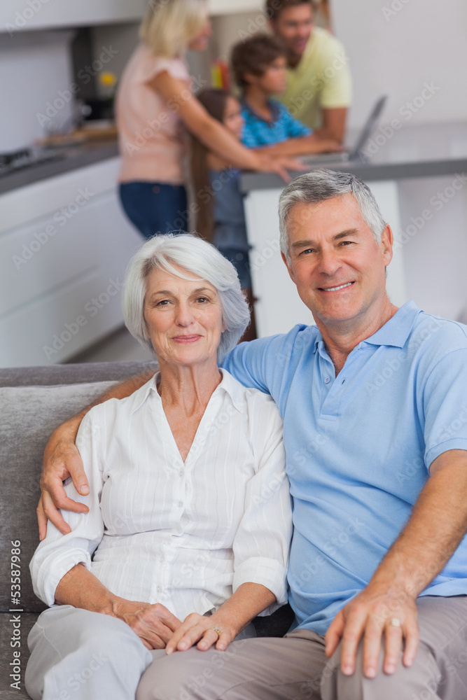 Portrait of a couple sitting on couch Portrait of a couple sitting on couch