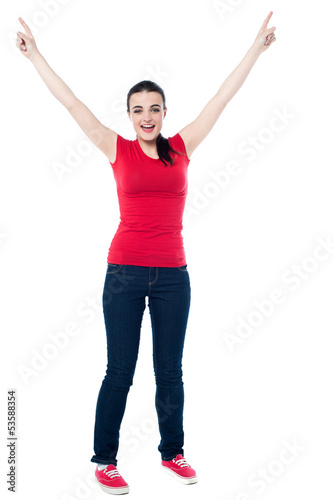 Joyous female raising arms in excitement