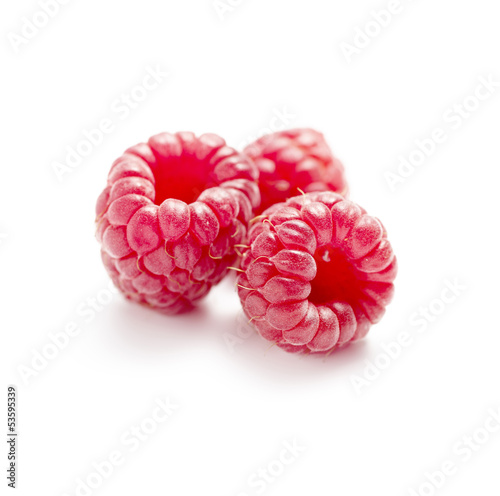 three raspberries isolated on white background with shadow