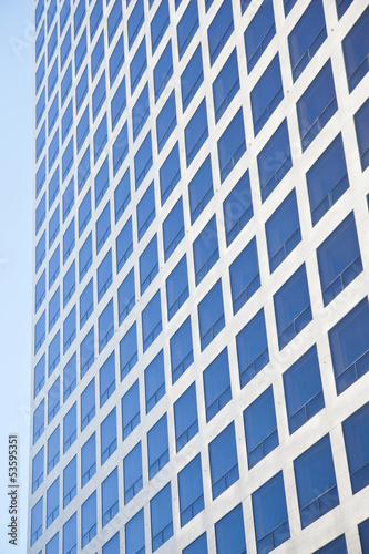 modern office building reflecting blue sky