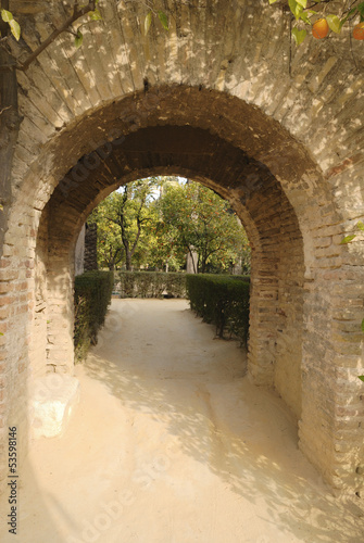 Brick arch in the gardens of the Alcazar of Seville  Spain