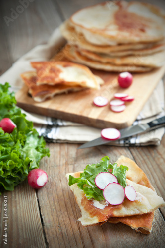 Homemade milk flatbread with cream cheese, lettuce and radish