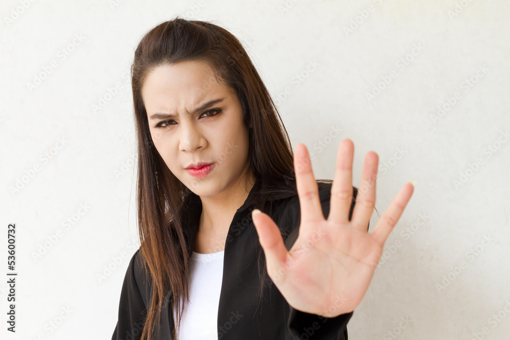 woman in business suit showing stop hand gesture woman in business suit showing stop hand gesture