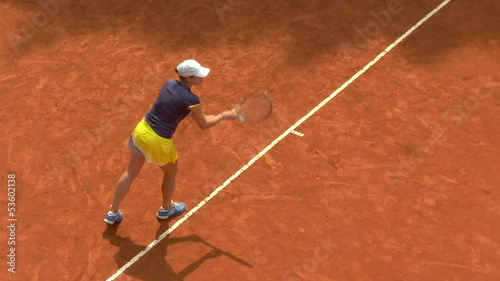 Girl play tennis outdoor on orange clay tennis court