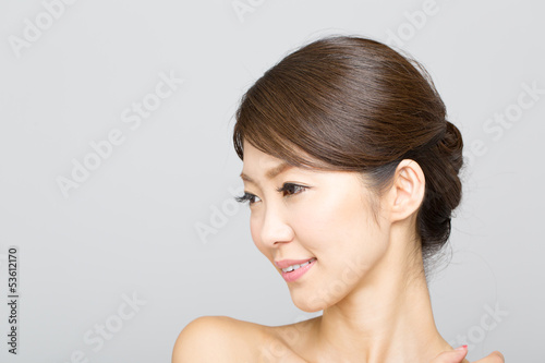 Beautiful asian woman isolated on gray background