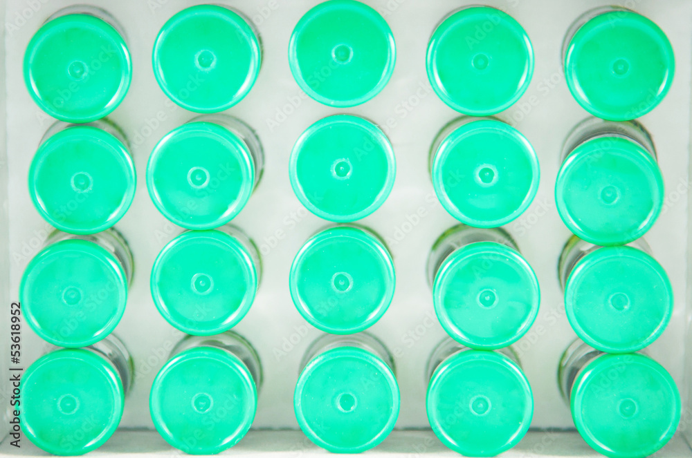 Fototapeta premium Closed up top view of injection vials on paper tray