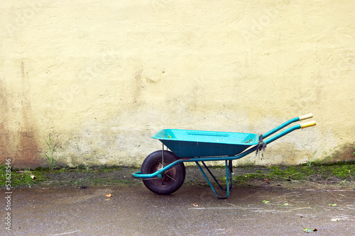 gardening wheelbarrow on a wall Fototapeta