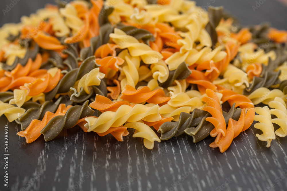 Fusilli spreading on black wood table Fusilli spreading on black wood table