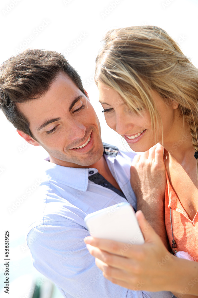 Portrait of sweet couple using smartphone Portrait of sweet couple using smartphone