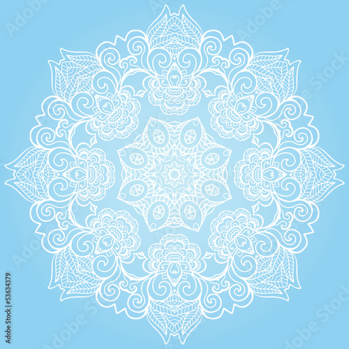 Round lace ornament isolated on blue.