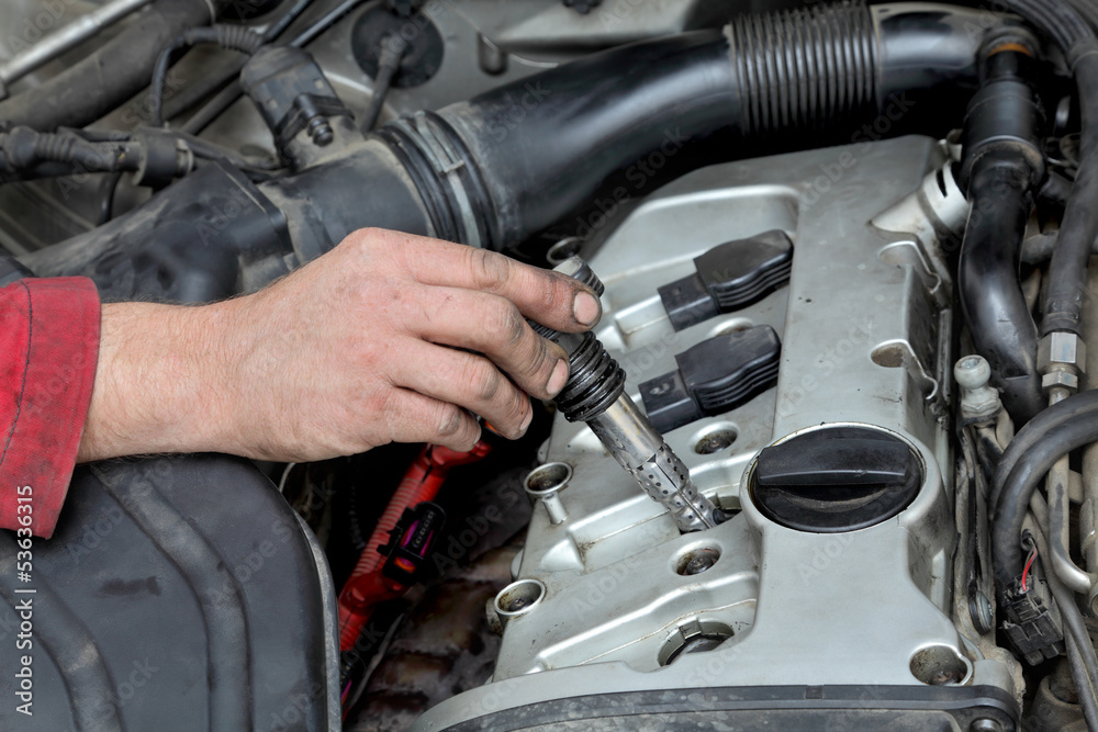 Φωτογραφία Car mechanic replacing ignition coil, gasoline engine