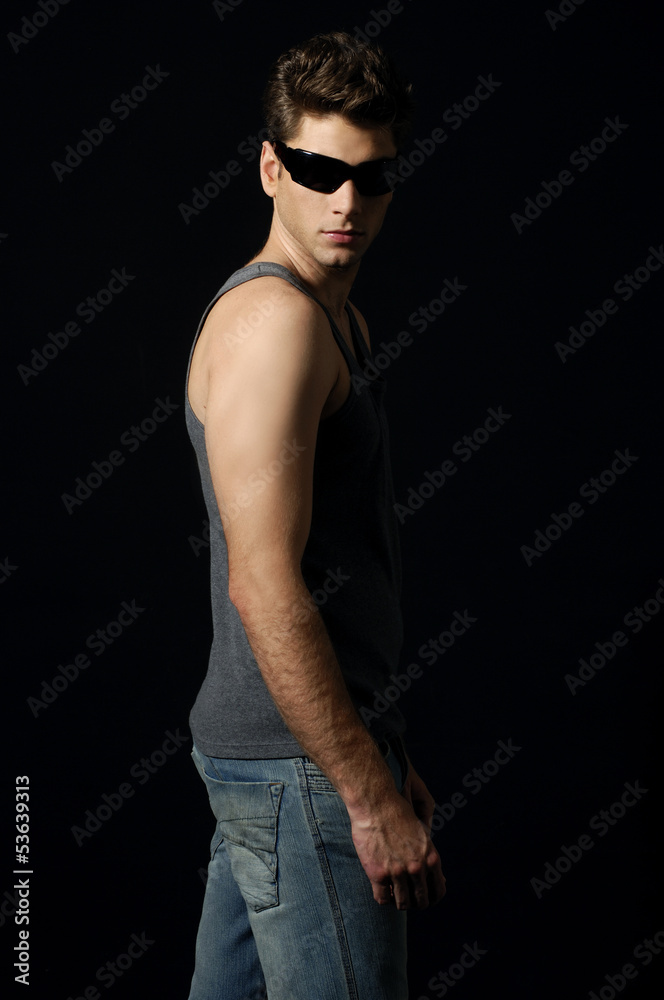 young man in sunglasses posing for the camera