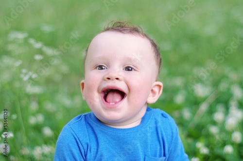portrait of happy smiling baby age of 9 months outdoors