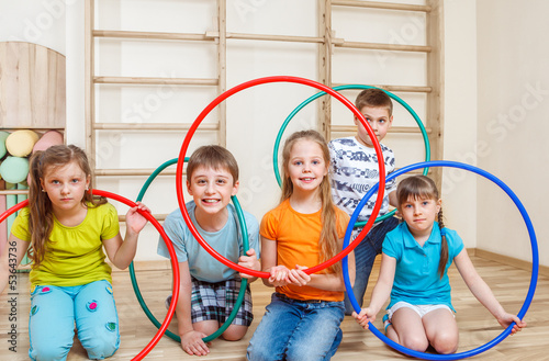 Kids holding hula hoops photo