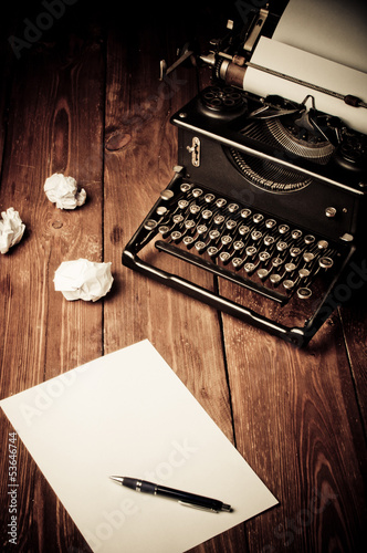 Vintage typewriter and a blank sheet of paper, retouching retro