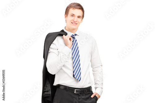 Young businessman posing with a coat over shoulder
