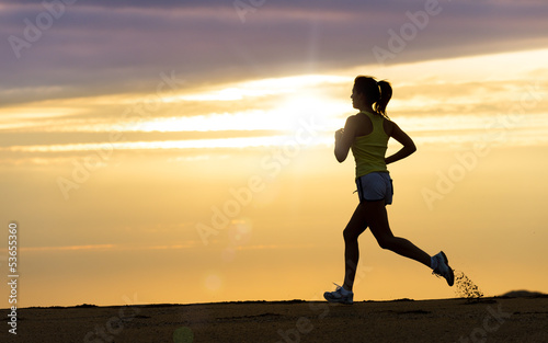 Fototapeta Naklejka Na Ścianę i Meble -  Athlete running at sunset on beach