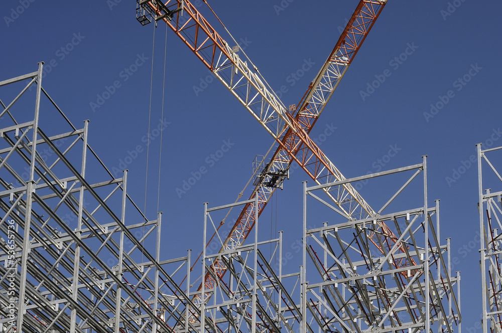 Steel structure of a high rack warehouse and a crane during cons